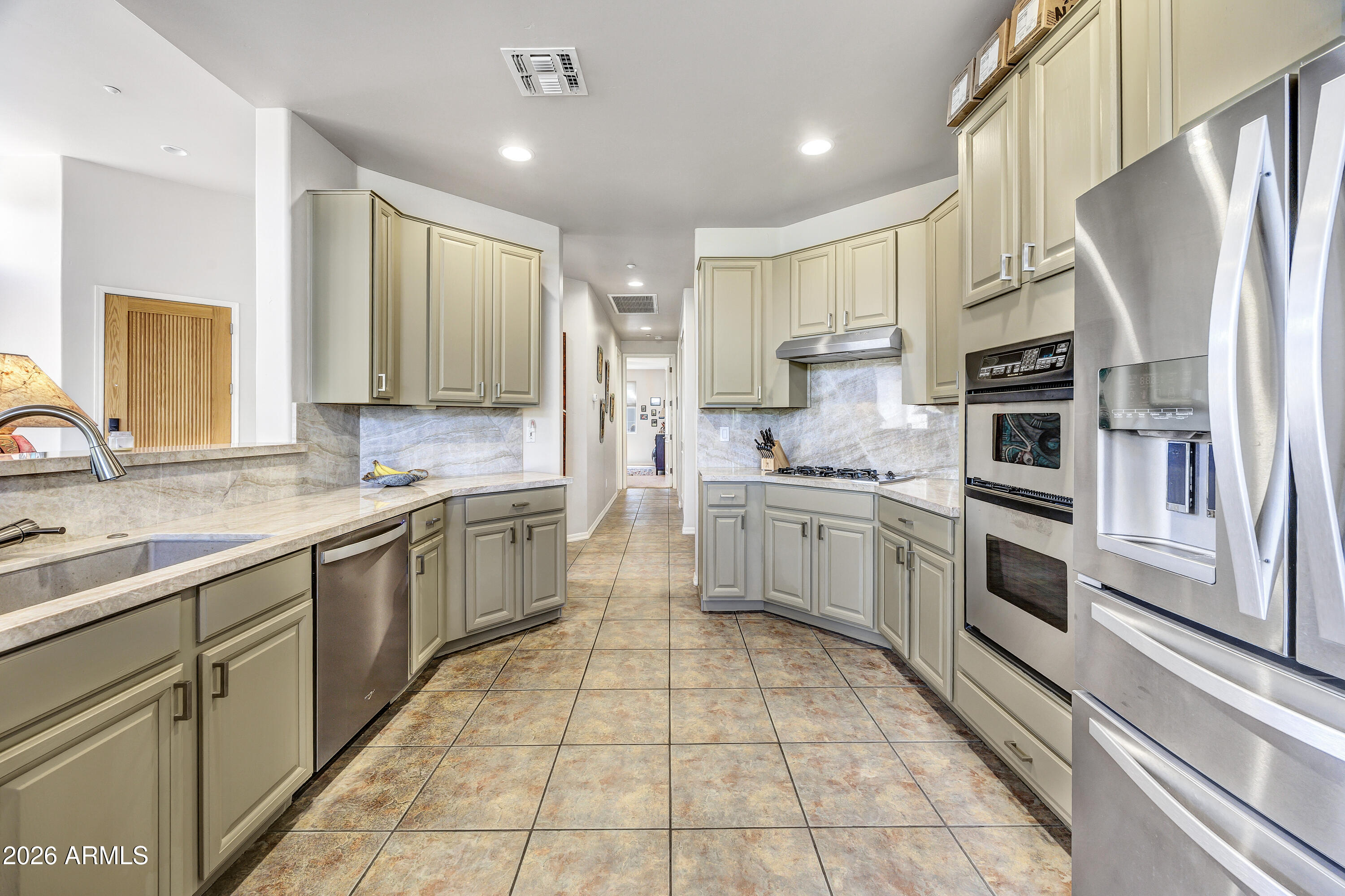 7402 Hum Road, Unit 19 Carefree, AZ 85377 - Photo 6 of 25 a kitchen with stainless steel appliances a refrigerator sink and cabinets
