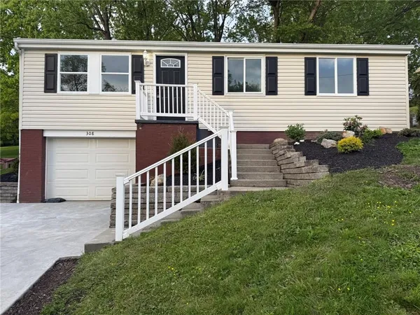 a view of backyard with deck and wooden fence