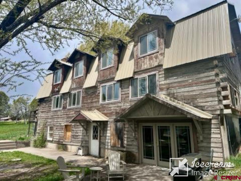 a front view of a residential apartment building with a yard