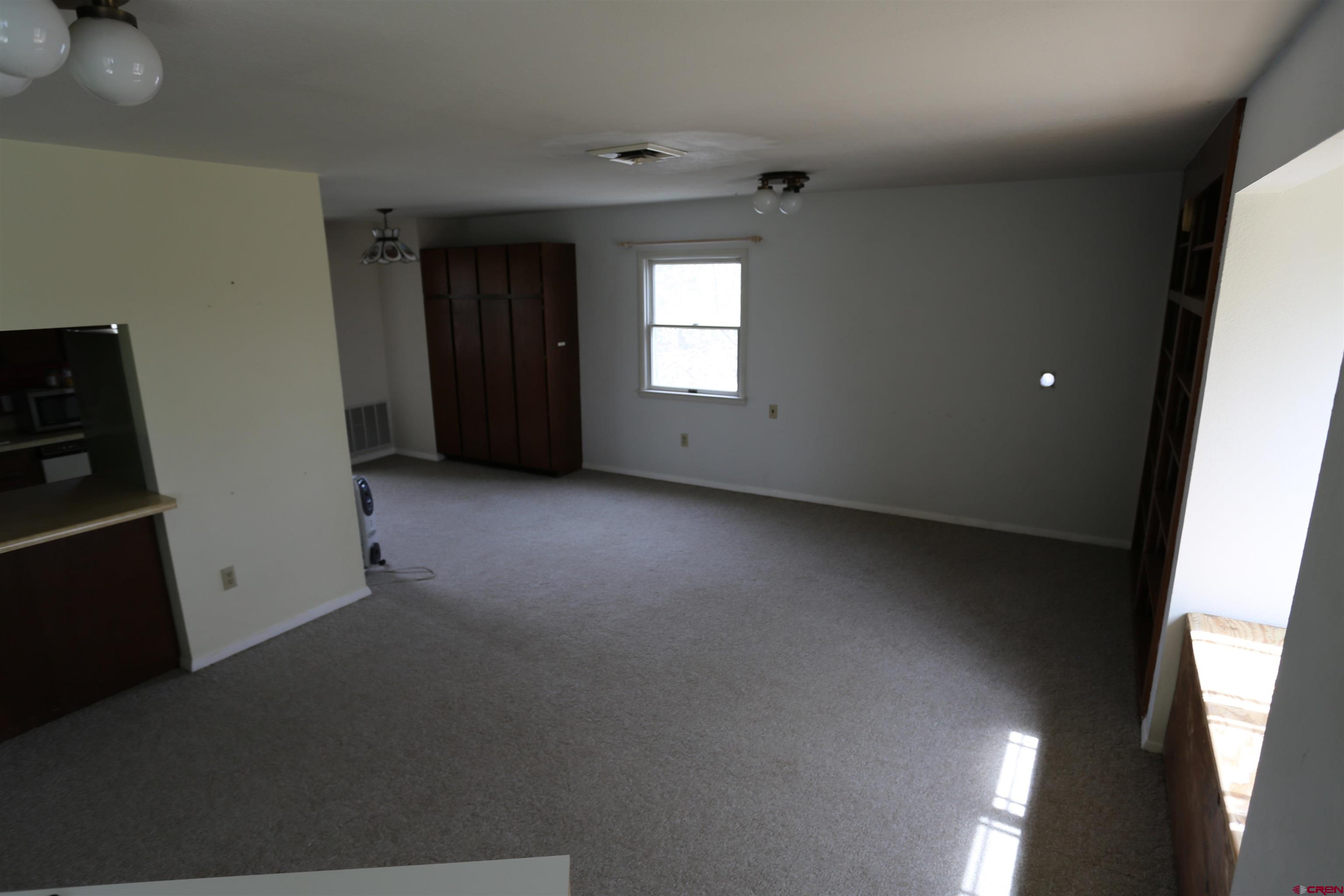 8654 Highway 172 Ignacio, CO 81137 - Photo 14 of 35 wooden floor and windows in an empty room