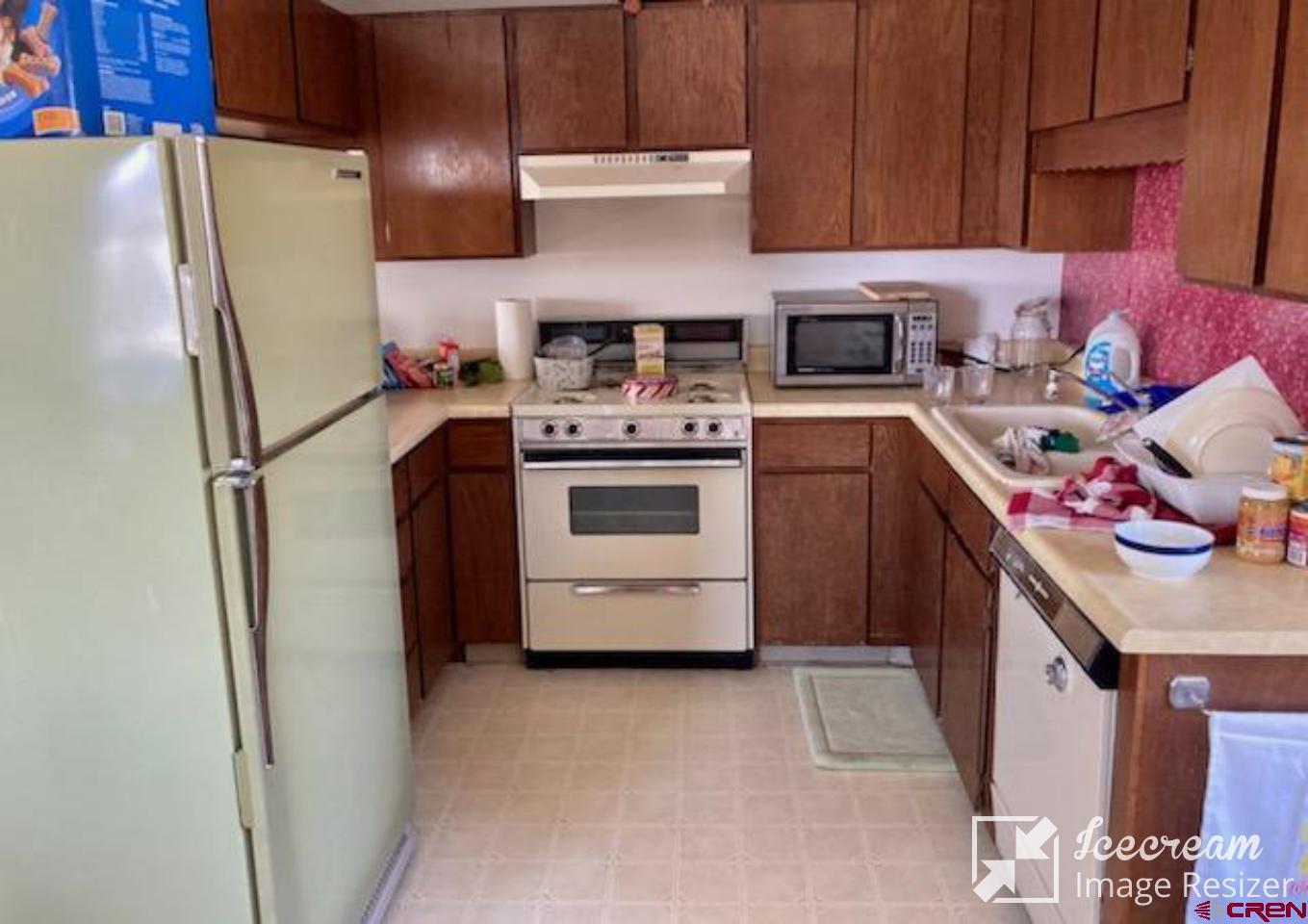 8654 Highway 172 Ignacio, CO 81137 - Photo 16 of 35 a kitchen with a refrigerator stove and sink