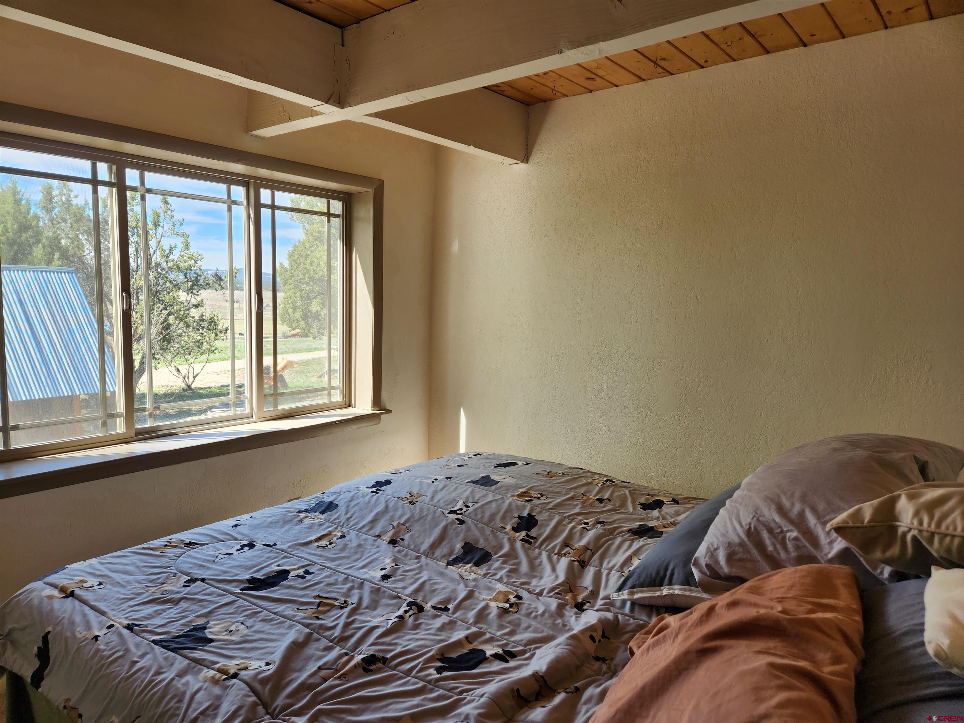 8654 Highway 172 Ignacio, CO 81137 - Photo 33 of 35 a bed sitting in a bedroom next to a window