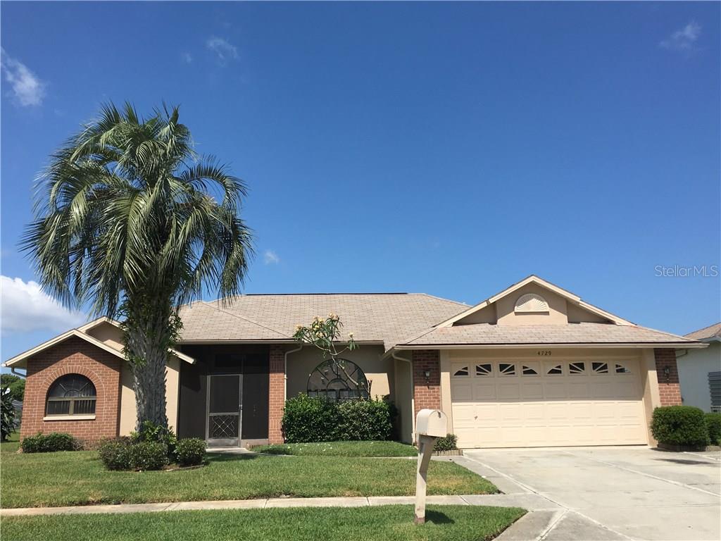 4729 Addax Drive New Port Richey, FL 34653 - Photo 1 of 1 a view of a white house with a small yard and a large tree