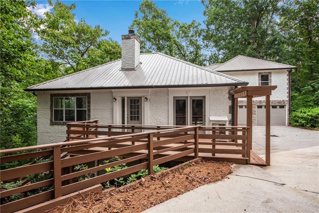 a view of house with a swing chair and a small yard