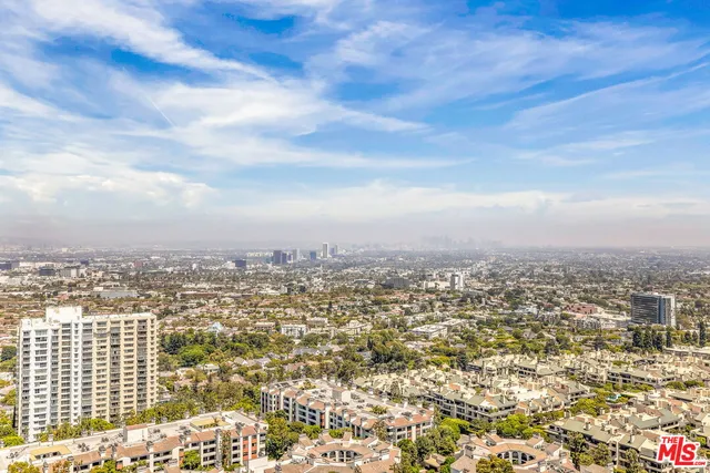 an aerial view of residential building and trees