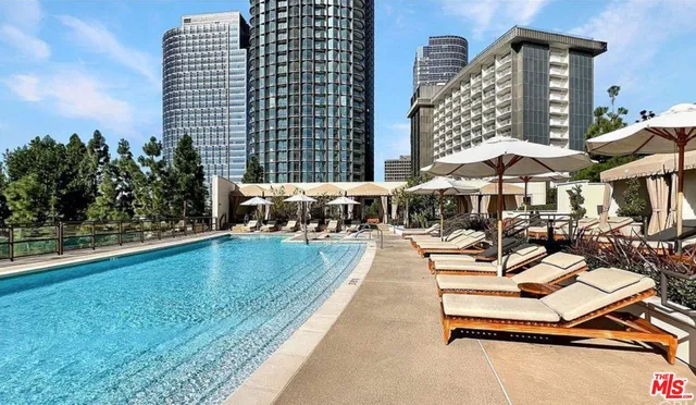 a view of a patio with chairs and tables with potted plants