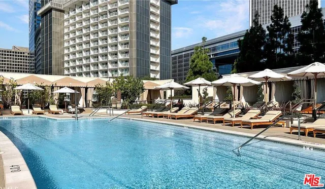 a view of a swimming pool with sitting area