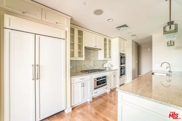 a kitchen with a stove a sink and a refrigerator