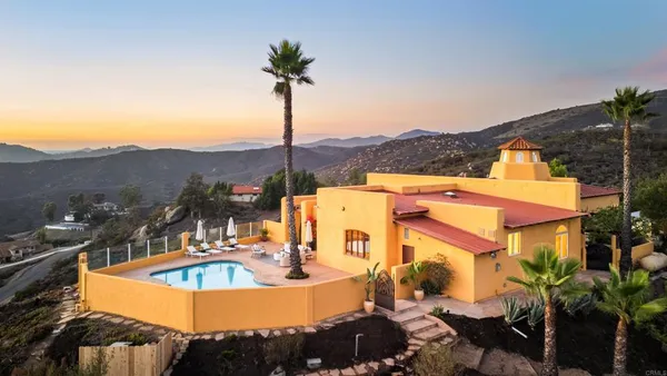 a view of a swimming pool with a garden and mountain view