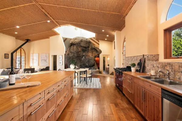 a kitchen with stainless steel appliances granite countertop a stove and a wooden cabinets
