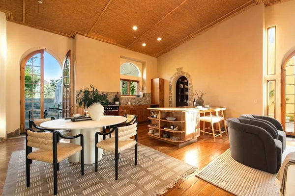 a living room with furniture cabinets and a rug