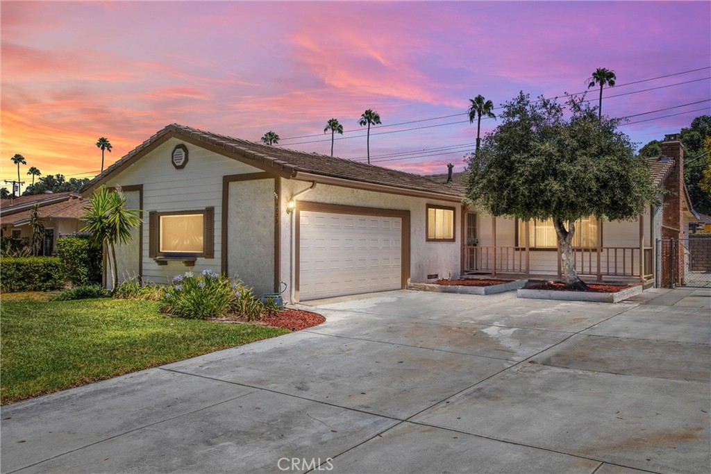 4075 Rees Street Riverside, CA 92504 - Photo 1 of 1 a front view of a house with a yard and garage