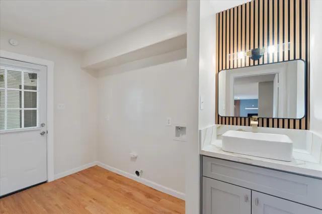 an entryway with wooden floor and windows