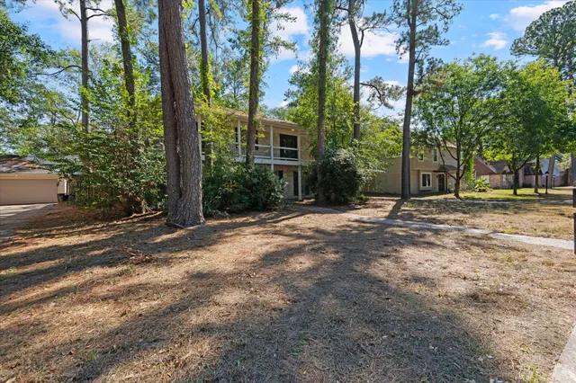 a view of a house with a tree in front