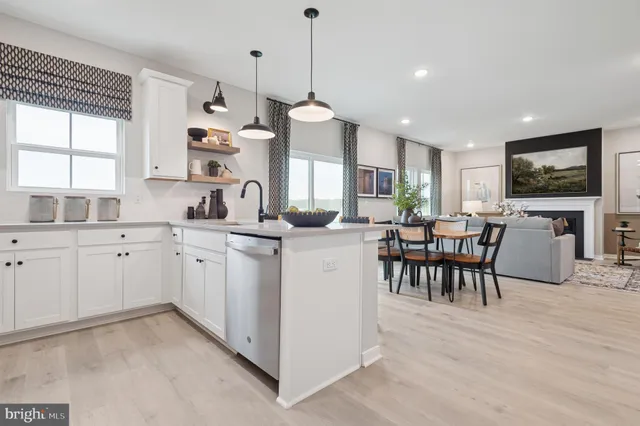 a kitchen with microwave a sink and cabinets