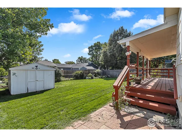 a view of a backyard with furniture and a slide