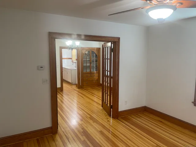 a view of a room with wooden floor