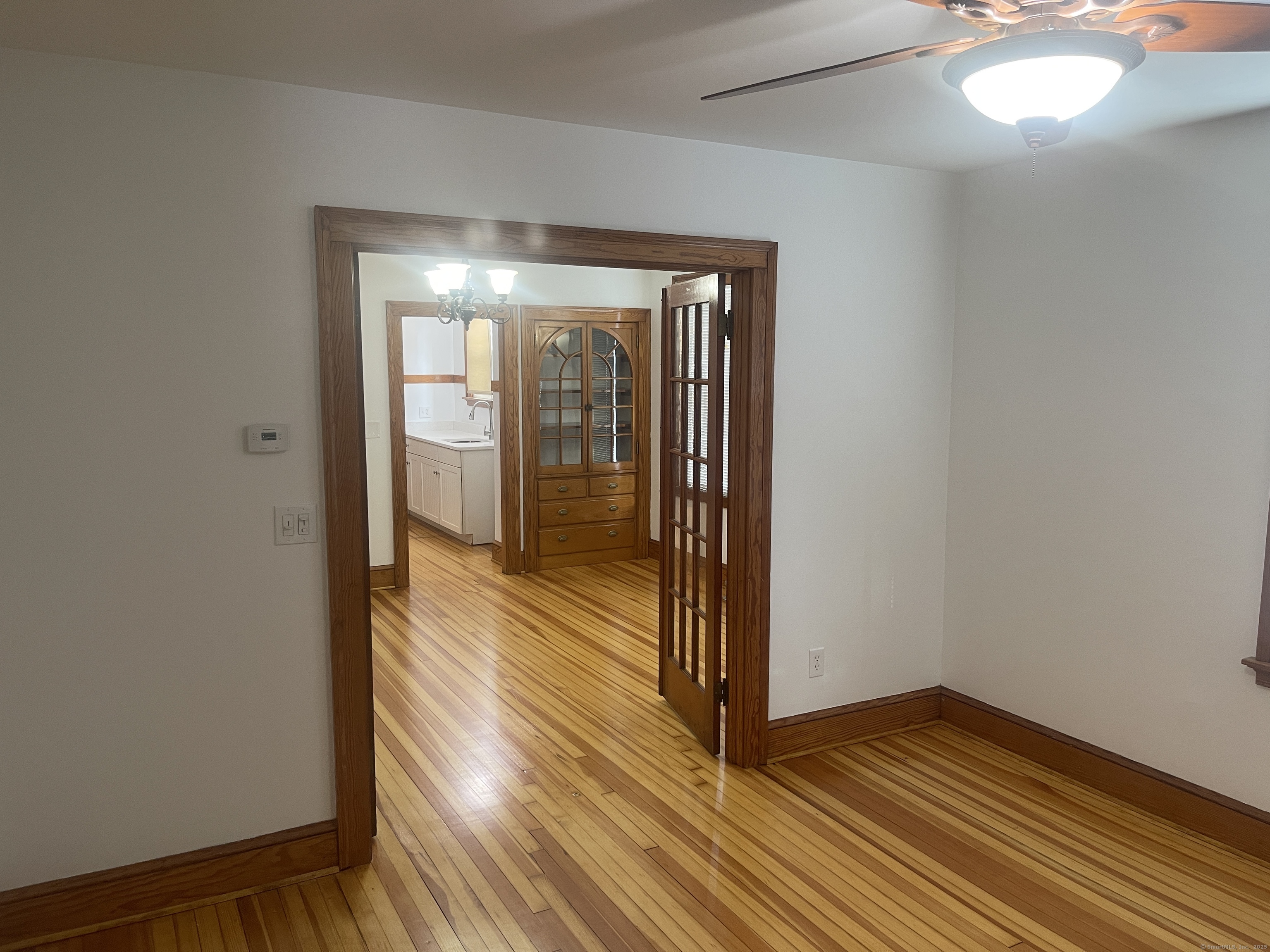 a view of a room with wooden floor