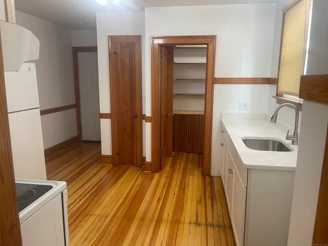 a kitchen with a sink and a refrigerator