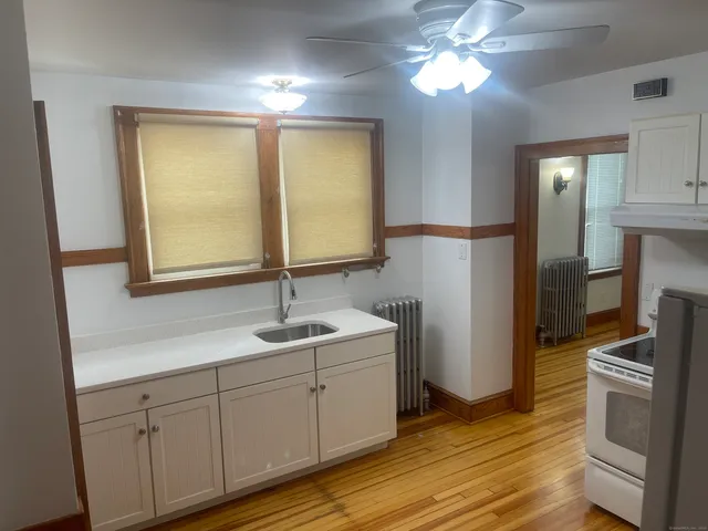 a kitchen with a sink and a refrigerator