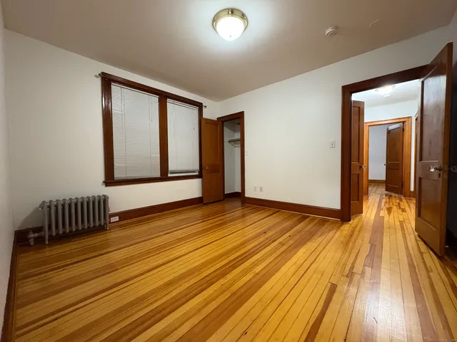 a view of a room with wooden floor and door