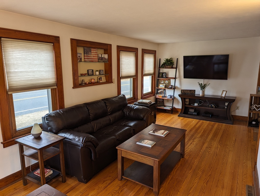 125 Plumtree Road Sunderland, MA 01375 - Photo 3 of 41 a living room with furniture and a flat screen tv