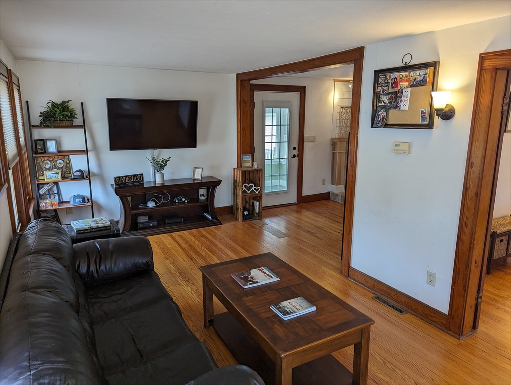 125 Plumtree Road Sunderland, MA 01375 - Photo 5 of 41 a living room with furniture and a flat screen tv