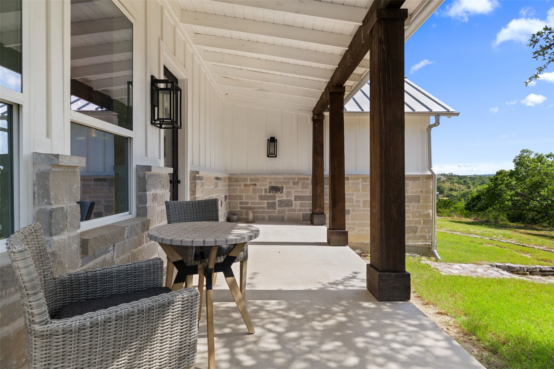 810 Kothmann Road Dripping Springs, TX 78620 - Photo 22 of 40 Massive timber columns and a stone facade frame this inviting covered porch.