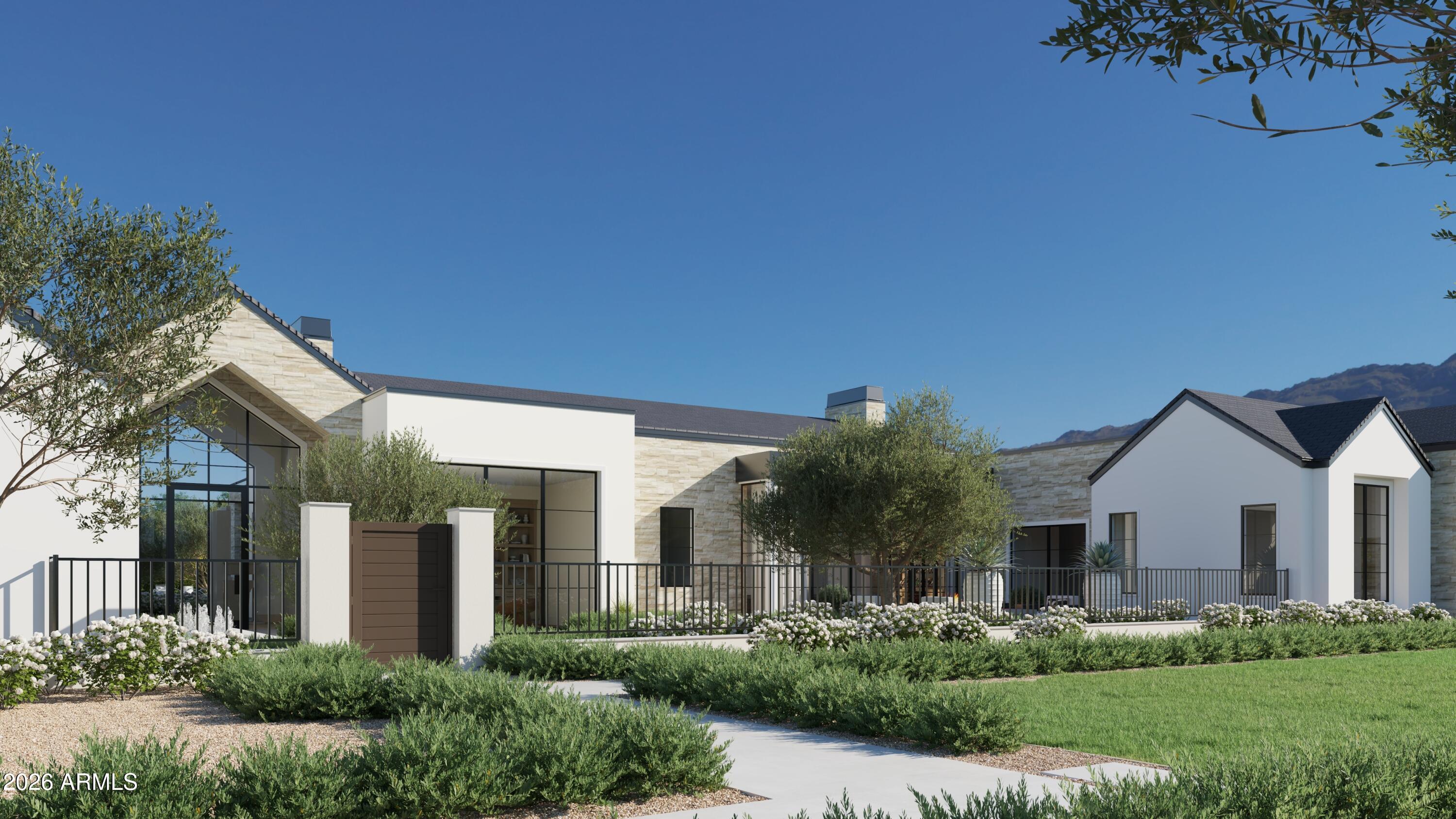 5009 East Roadrunner Road Paradise Valley, AZ 85253 - Photo 2 of 36 a front view of a house with garden