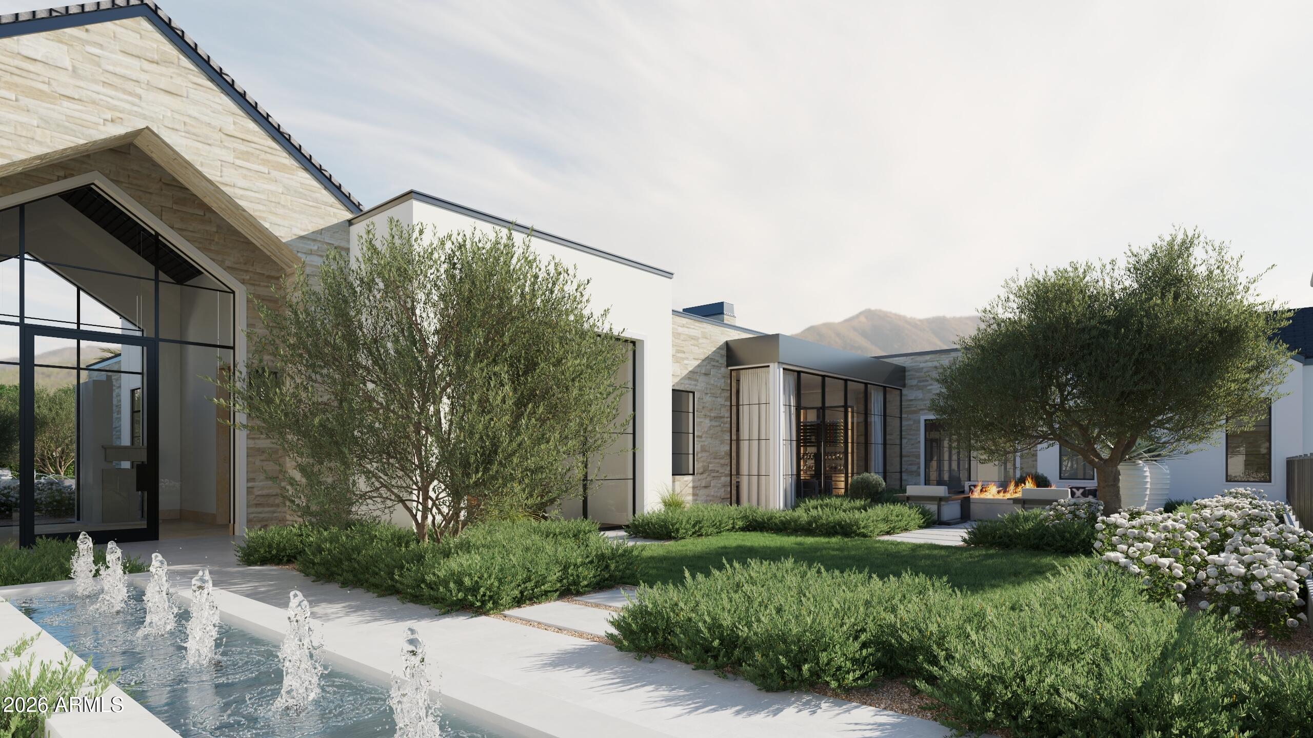 5009 East Roadrunner Road Paradise Valley, AZ 85253 - Photo 3 of 36 a view of a house with brick walls and a yard with plants