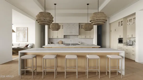 a kitchen with a chandelier a sink stainless steel appliances and cabinets