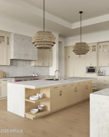 a kitchen with stainless steel appliances granite countertop a sink a stove and a chandelier