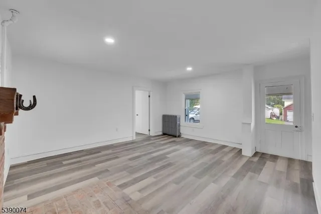 an empty room with closet and windows