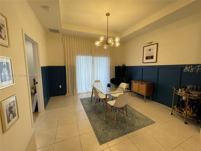 a view of a house with patio area and garden