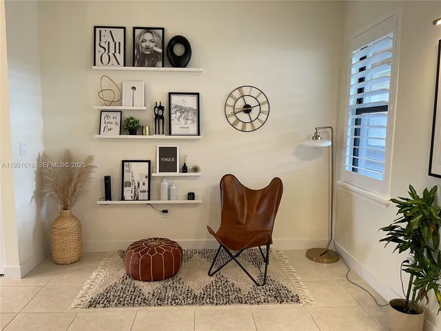 a large white kitchen with a large counter top and stainless steel appliances