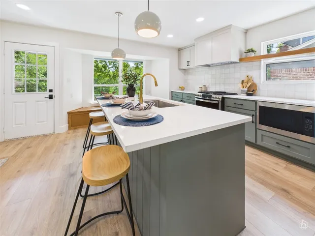 a kitchen with sink cabinets dining table and chairs