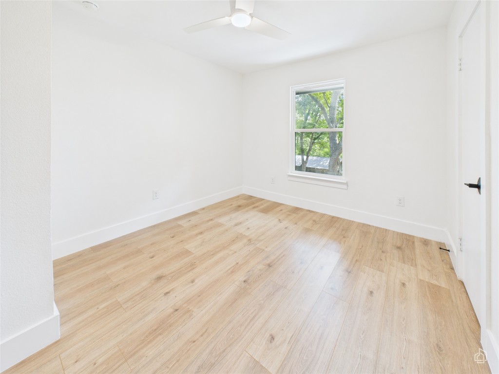 7019 Creighton Lane Austin, TX 78723 - Photo 27 of 40 an empty room with wooden floor and window