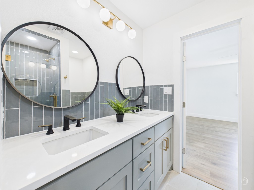 7019 Creighton Lane Austin, TX 78723 - Photo 28 of 40 a bathroom with a sink and a mirror