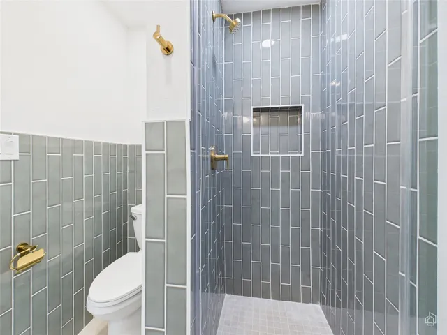 a bathroom with a toilet and shower