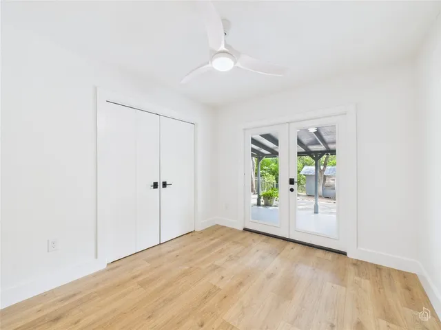 an empty room with windows and closet