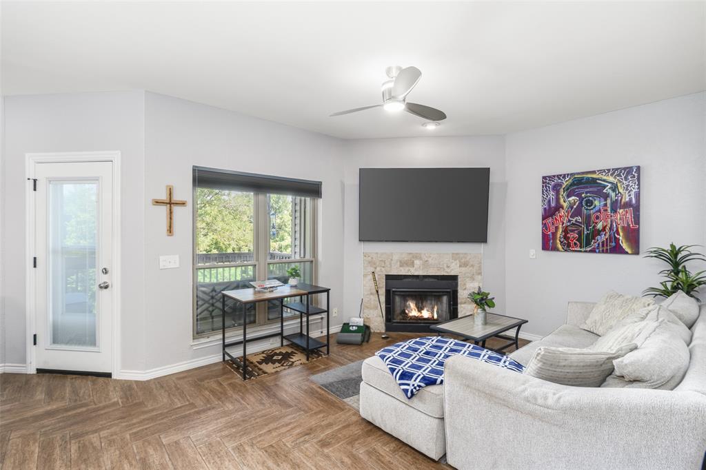 7340 Skillman Street, Unit 1113 Dallas, TX 75231 - Photo 12 of 31 Living Room with Lots of Natural Light, Woodburning Fireplace... Opens to Covered Bacony with Amazing Views & Privacy!