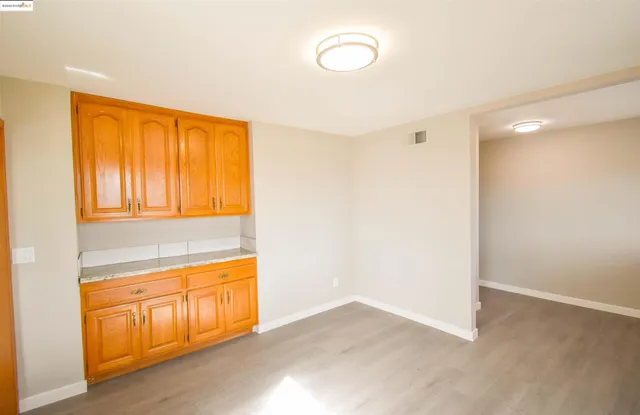a large kitchen with granite countertop a sink stainless steel appliances and cabinets