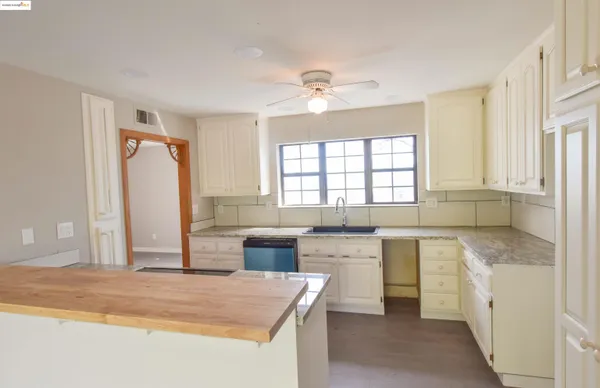 a kitchen with wooden floors and appliances