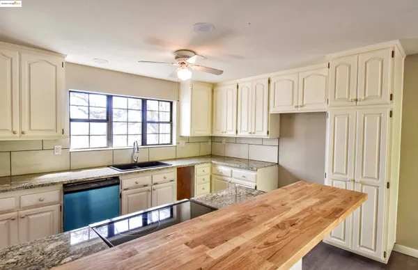 a kitchen with a sink and large window