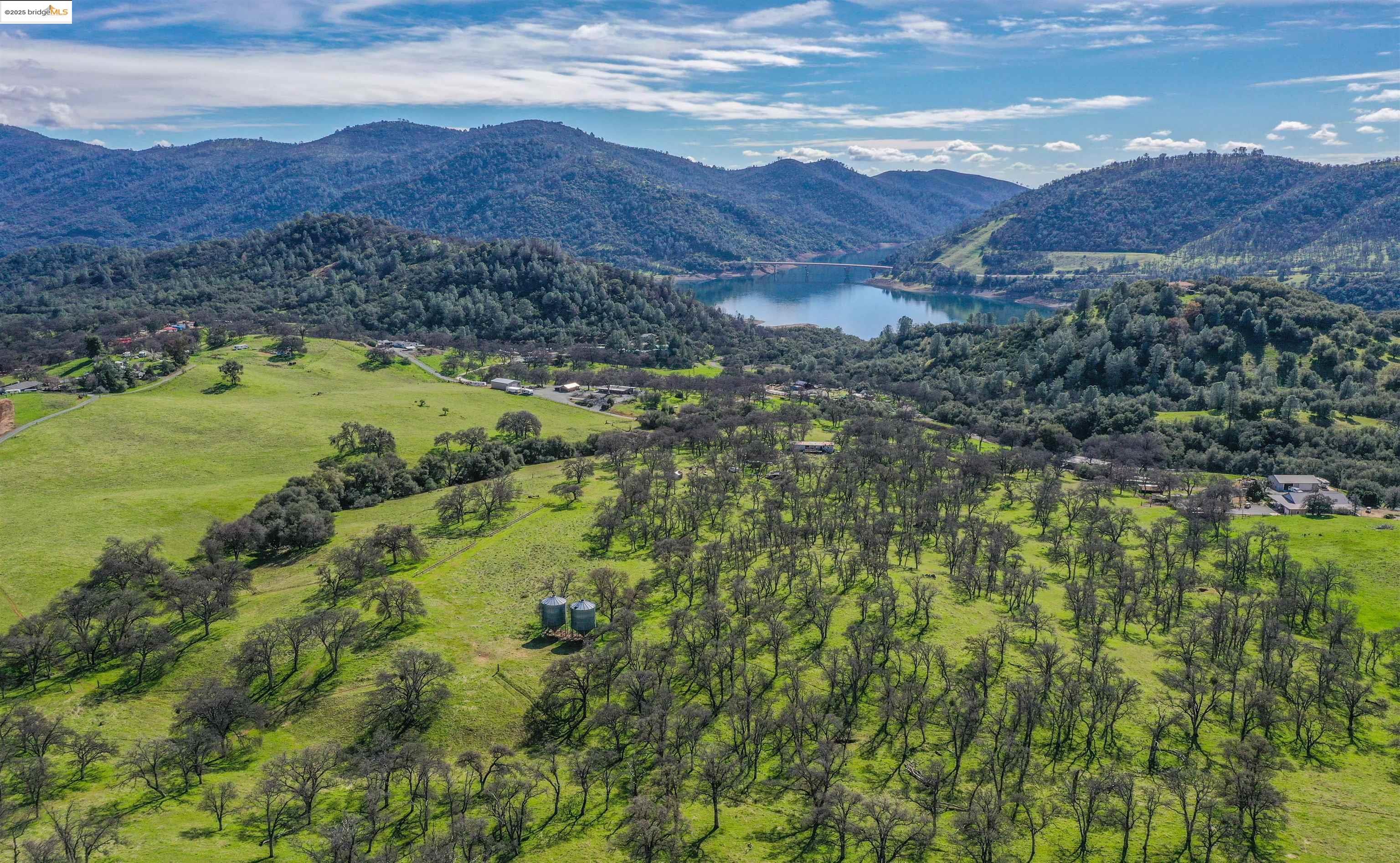 13300 Lone Bend Road Jamestown, CA 95327 - Photo 2 of 50 a view of a lush green hillside and a houses