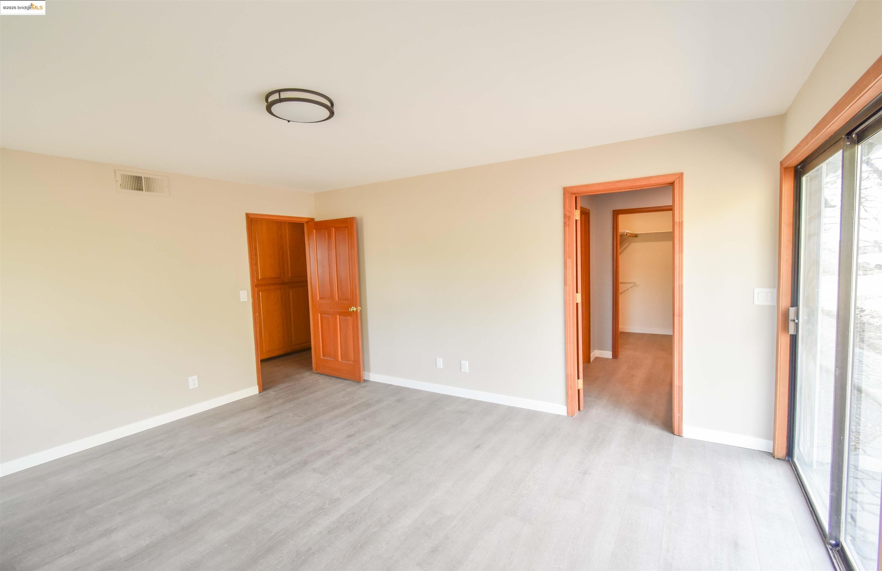 13300 Lone Bend Road Jamestown, CA 95327 - Photo 25 of 50 a view of an empty room with wooden floor and a window