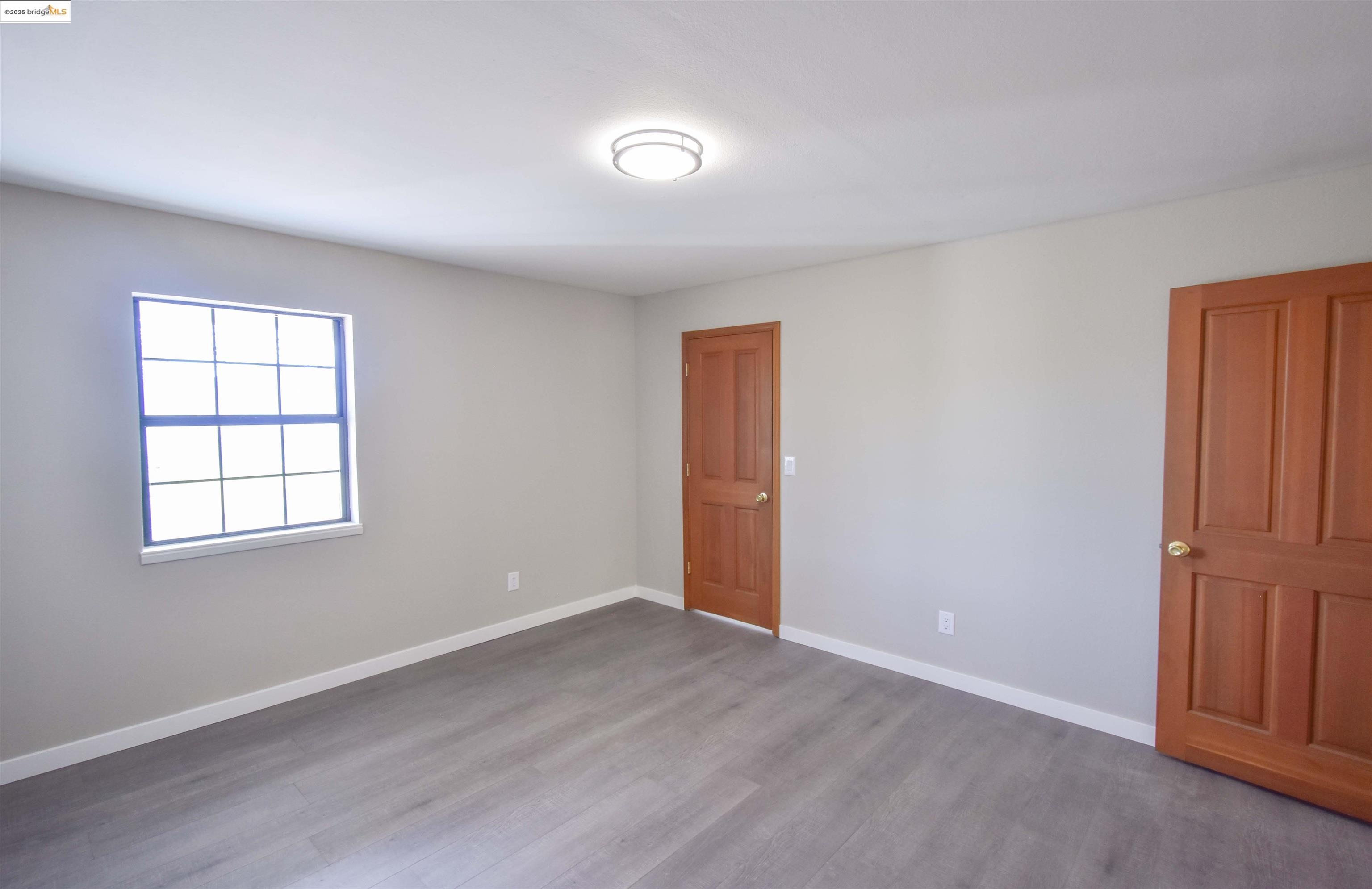 13300 Lone Bend Road Jamestown, CA 95327 - Photo 34 of 50 an empty room with wooden floor closet and windows
