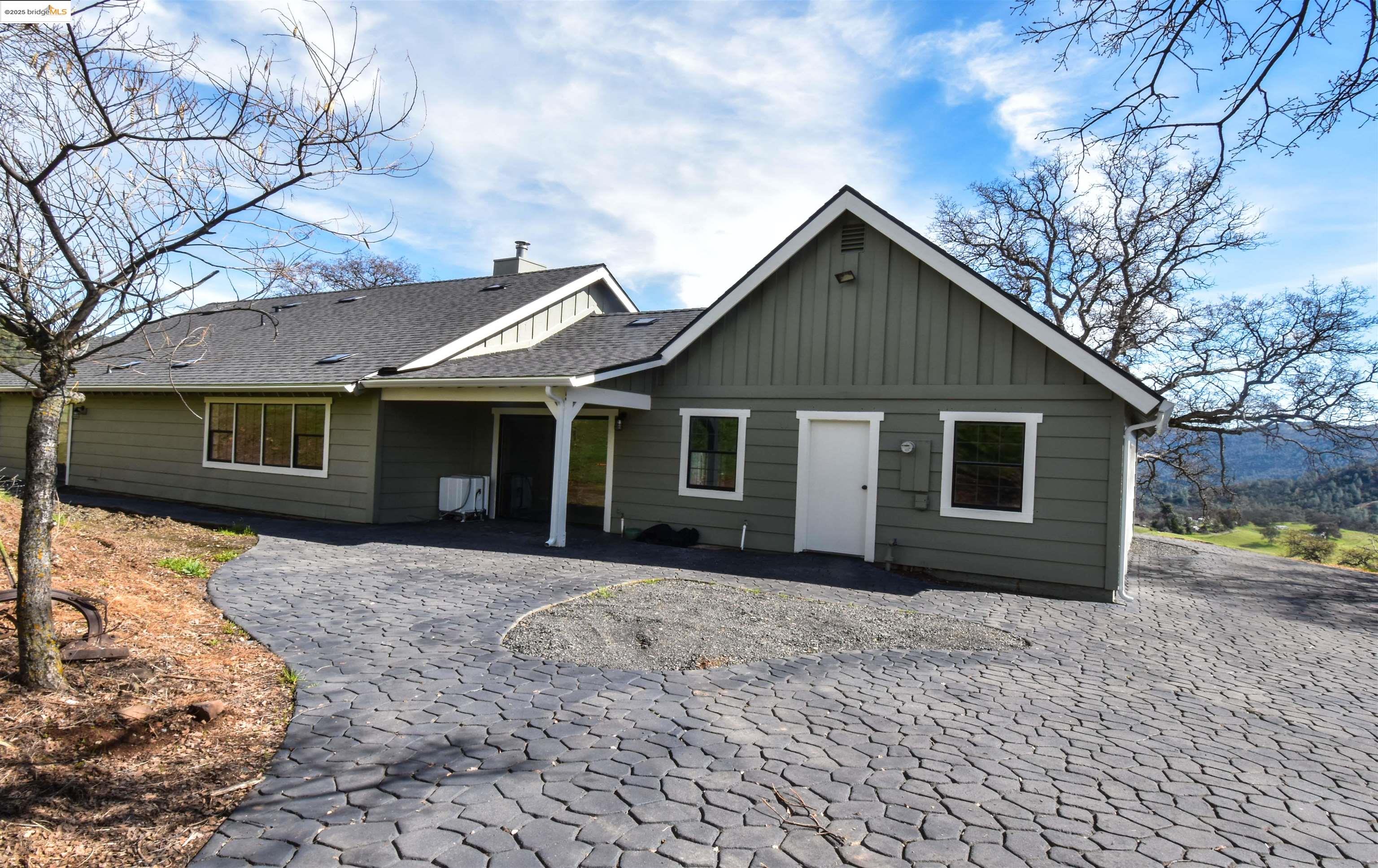 13300 Lone Bend Road Jamestown, CA 95327 - Photo 35 of 50 a front view of a house with a yard and garage