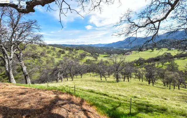 a view of a mountain with a yard