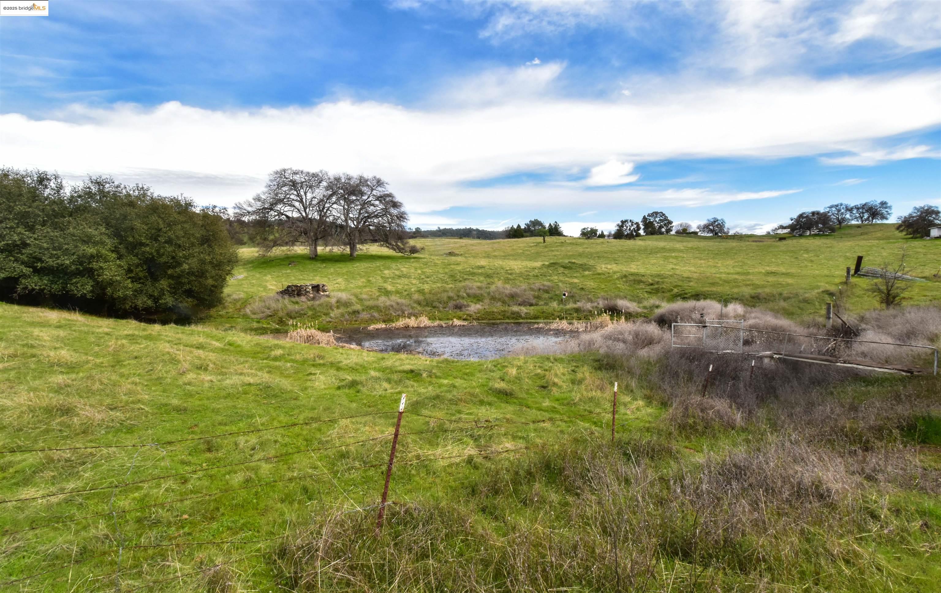 13300 Lone Bend Road Jamestown, CA 95327 - Photo 6 of 50 a view of a lake with houses in the background
